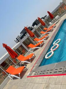 a row of lounge chairs next to a swimming pool at فندق مروج نجد in Jeddah