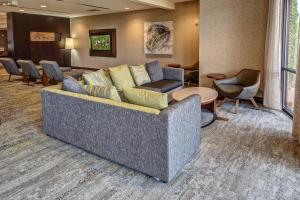 a living room with a couch and chairs in a room at Courtyard Lima in Lima