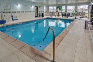 a large pool with blue water in a building at Courtyard Lima in Lima