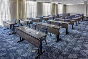 a classroom with desks and chairs in a room at Courtyard Rochester Downtown in Rochester