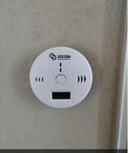 a white sensor on the wall of a room at Lu-Mar in Comodoro Rivadavia