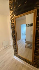 a mirror on a wall in a room at Stunning Modern 2bed Apt Near Dublin City& Airport in Dublin