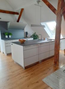 a kitchen with white cabinets and a sink at Luxuriöses Loft mit schönem Blick in Tremsbüttel