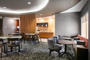a restaurant with tables and chairs and a counter at SpringHill Suites by Marriott Cheyenne in Cheyenne