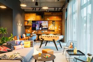 a living room with a ping pong table at Moxy Berlin Airport in Schönefeld