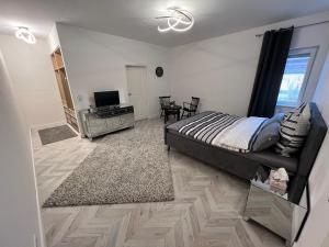 a bedroom with a bed and a television in it at Krügers Apartment in Barsinghausen