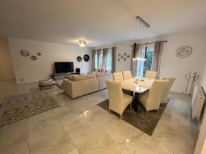 a living room with a table and a couch at Krügers Apartment in Barsinghausen