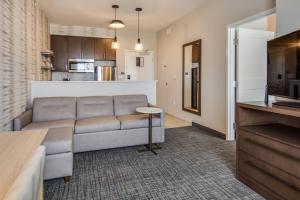 a living room with a couch and a kitchen at Residence Inn by Marriott Dallas DFW Airport West/Bedford in Bedford