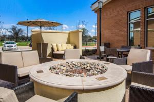 a fire pit in a patio with chairs and an umbrella at Residence Inn by Marriott Dallas DFW Airport West/Bedford in Bedford