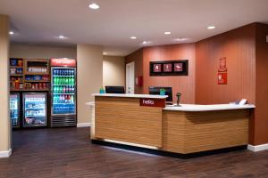 a hotel lobby with a counter and a drink cooler at TownePlace Suites by Marriott St. Louis Chesterfield in Chesterfield