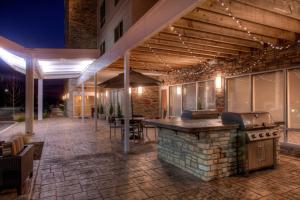 an outdoor bar with a grill on a patio at TownePlace Suites by Marriott St. Louis Chesterfield in Chesterfield
