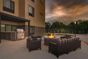 a patio with chairs and a fire pit in front of a building at TownePlace Suites by Marriott Dallas Mesquite in Mesquite