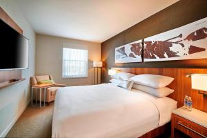 a hotel room with a large bed and a flat screen tv at Delta Hotels by Marriott Dartmouth in Halifax