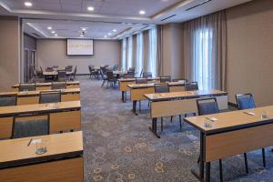 a classroom with tables and chairs in a room at Courtyard by Marriott Petoskey at Victories Square in Petoskey