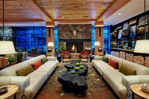 a living room with a couch and a fireplace at The Cloudveil, Autograph Collection in Jackson