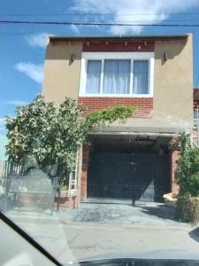 a house with a garage in front of it at Lu-Mar in Comodoro Rivadavia