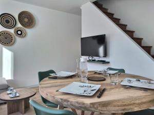 a dining room with a wooden table and chairs at Le Grand Evali - WIFI - Centre in Albi