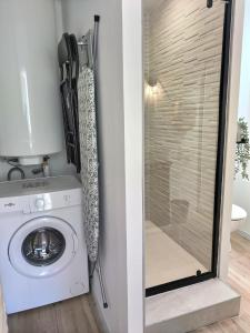 a laundry room with a washing machine and a glass door at Le Grand Evali - WIFI - Centre in Albi