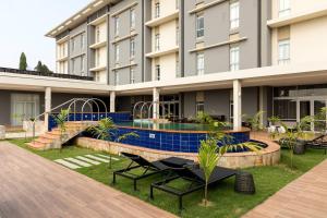 a view of a building with a swimming pool at Protea Hotel by Marriott Owerri Select in Owerri