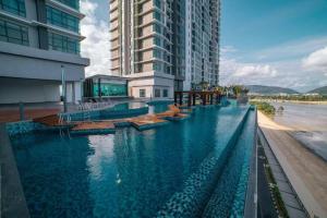 a large swimming pool next to a tall building at Best moments in Kuantan