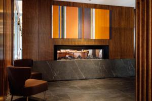 a lobby with a fireplace and a chair at The Tasman, a Luxury Collection Hotel, Hobart in Hobart