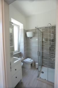 a bathroom with a toilet and a sink and a shower at B&B Nonna Maria in Termoli