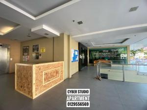 a lobby of a restaurant with a counter in a building at Cyber Studio Apartment in Kota Bharu