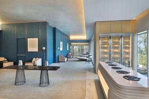a living room with blue walls and a table at W Dubai - Mina Seyahi in Dubai +37 photos