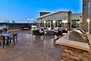 a patio with tables and chairs and a grill at Residence Inn by Marriott Eau Claire in Eau Claire