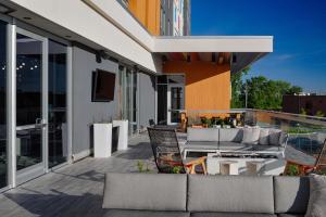 a patio with a couch and chairs on a building at Aloft Columbus in Columbus