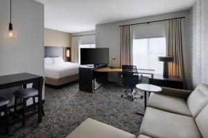 a hotel room with a bed and a desk at Residence Inn Waco South in Waco