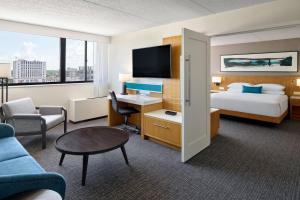 a hotel room with a bed and a desk at Delta Hotels by Marriott Muskegon Convention Center in Muskegon