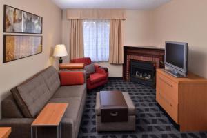 a living room with a couch and a fireplace at TownePlace Suites Detroit Warren in Warren