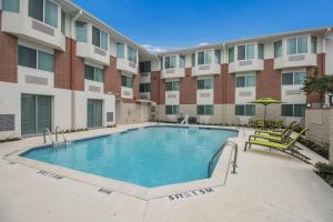 a swimming pool in front of a building at SpringHill Suites by Marriott Dallas NW Highway at Stemmons / I-35East in Dallas