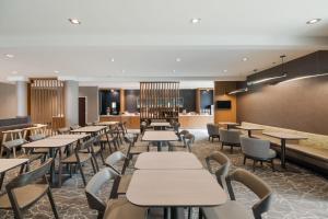 a restaurant with tables and chairs and a bar at SpringHill Suites by Marriott Dallas NW Highway at Stemmons / I-35East in Dallas