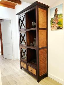 a wooden book shelf in a living room at Casa Mi Mona in Santa Cruz de la Palma