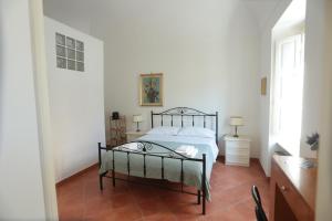 a bedroom with a bed in a white room at B&B Nonna Maria in Termoli