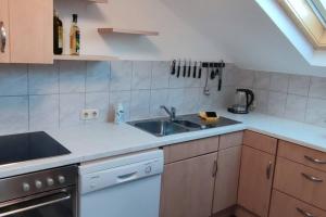 a kitchen with a sink and a stove at Illerblick in Blaichach