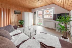 a living room with a couch and a table at Apartments Farm House Uric in Jesenice