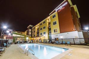 a pool in front of a hotel at night at Residence Inn by Marriott Harlingen in Harlingen