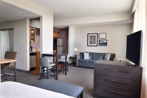 a living room with a couch and a kitchen and a living room at Residence Inn by Marriott London Canada in London
