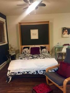 een slaapkamer met een bed en een plafondventilator bij Mill Hill Haven in Victoria