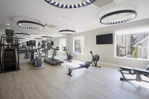 a gym with several treadmills and elliptical machines at Hotel Bella Grace in Charleston