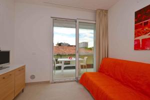 a living room with a couch and a table with a view at Apartments in Lignano 21707 in Lignano Sabbiadoro