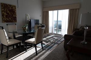 a living room with a table and chairs and a couch at The Point Hotel & Suites - 705S Luxury - Pool view - Close to Universal in Orlando