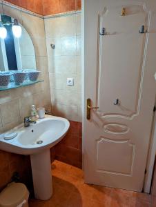 a bathroom with a sink and a shower at Lichnides Maisonette in Mola Kalyva +13 photos