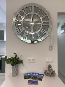 a large clock on the wall above a table at Sunshine Homes Zamárdi in Zamárdi +141 photos