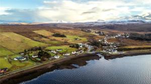 an aerial view of a village next to a body of water at Tigh Na Mara Holiday Home in Aultbea