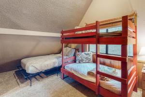a bedroom with two bunk beds and a small bed at Lone Star Lake House in Eureka Springs