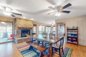 a dining room with a table and a fireplace at Lone Star Lake House in Eureka Springs